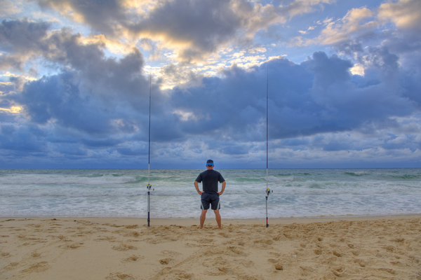 Photo of man fishing in the surf