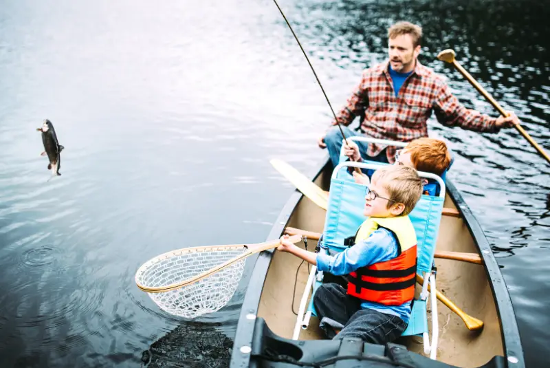 Photo of family fishing from a canoe