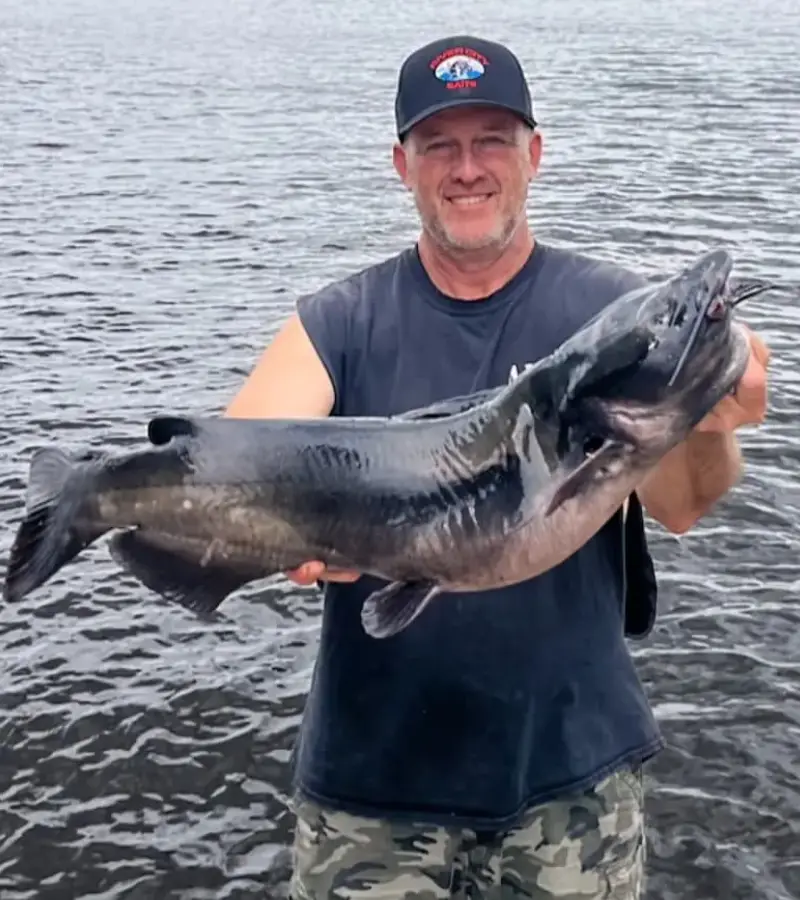 Photo of an angler holding a large channel catfish caught with a sliding sinker rig